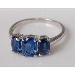 A contemporary 9ct white gold and sundar kyanite set dress ring, the three kyanite stones weighing