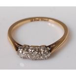 An 18ct gold diamond three stone ring, the old cut centre stone weighing approx 0.12 carats, 2.3g,