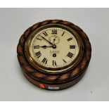 An early 20th century wall clock having an enamel dial with Roman numerals and subsidiary seconds