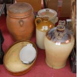 A large stoneware 2 gallon flagon impressed TCH together with one other two tone flagon,