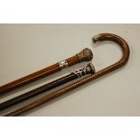 A circa 1900 malacca walking cane having white metal collar and embossed white metal mount, together