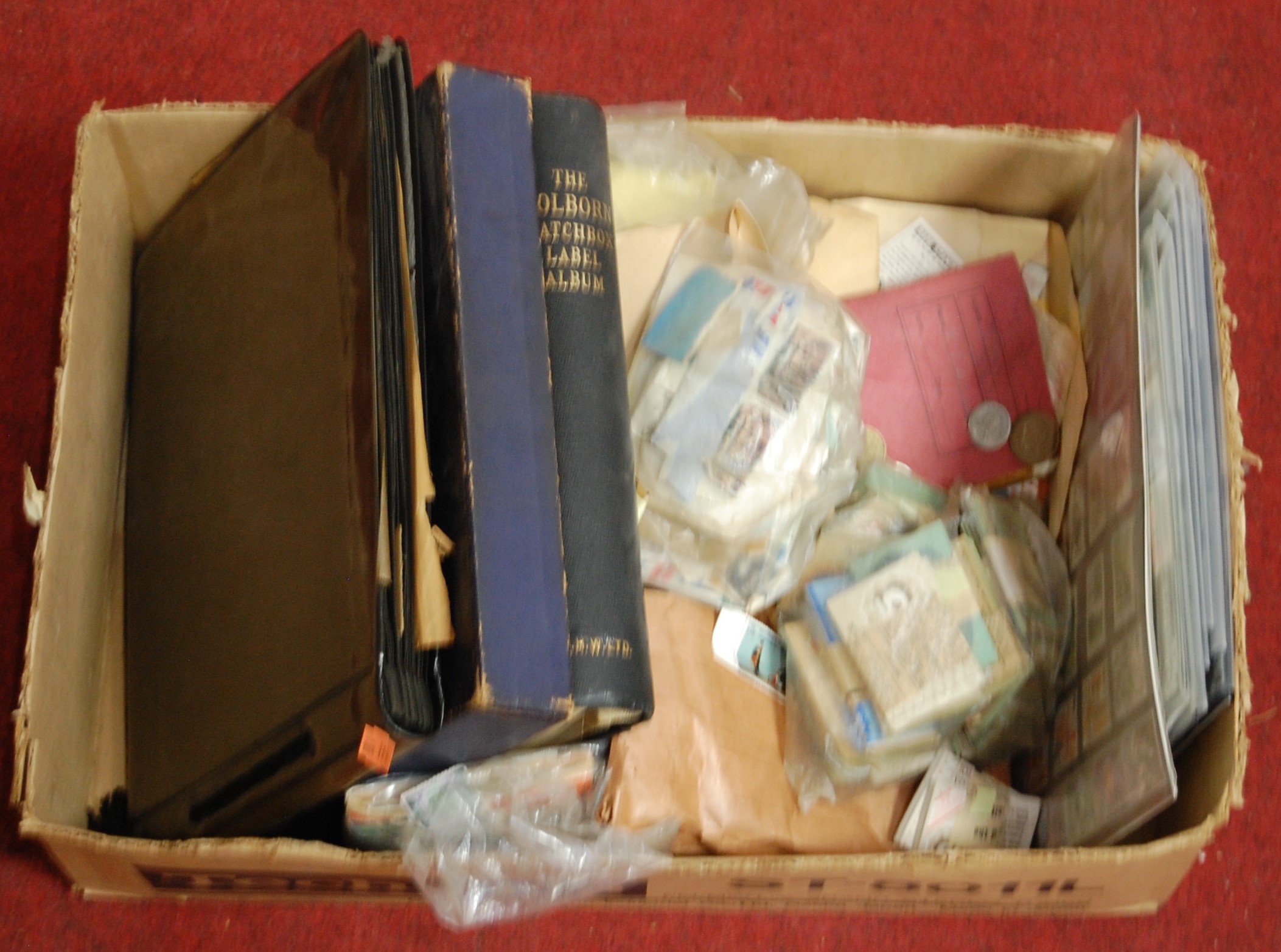 A box containing various first day covers, coins and stamps (mainly loose)