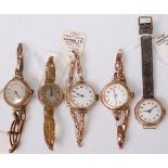 Three vintage lady's 9ct gold cased wristwatches, each having white enamel dial; together with two