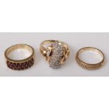 A 9ct gold garnet set dress ring; together with a 10ct gold diamond dress ring, arranged as three