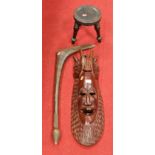 A carved softwood tribal style wall mask together with a small tribal three legged stool, and a