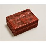 An early 20th century Chinese cinnabar lacquered table cigarette box, of rectangular form, the lid