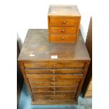 An oak eight drawer collector's chest containing a quantity of watchmaker's and watch repairer's