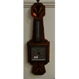 A 1930s Art Deco walnut wall barometer, having ebony strung and walnut crossbanded decoration