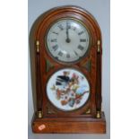 A late 19th century continental walnut cased dome top mantel clock, having a silvered dial with