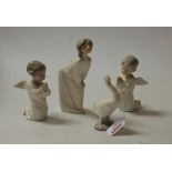 A pair of Lladro porcelain figures, each in the form of a cherub in kneeling prayer pose, h.13cm;