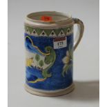 An 18th century Delft tankard, on a blue ground the central panel depicting a bull within a