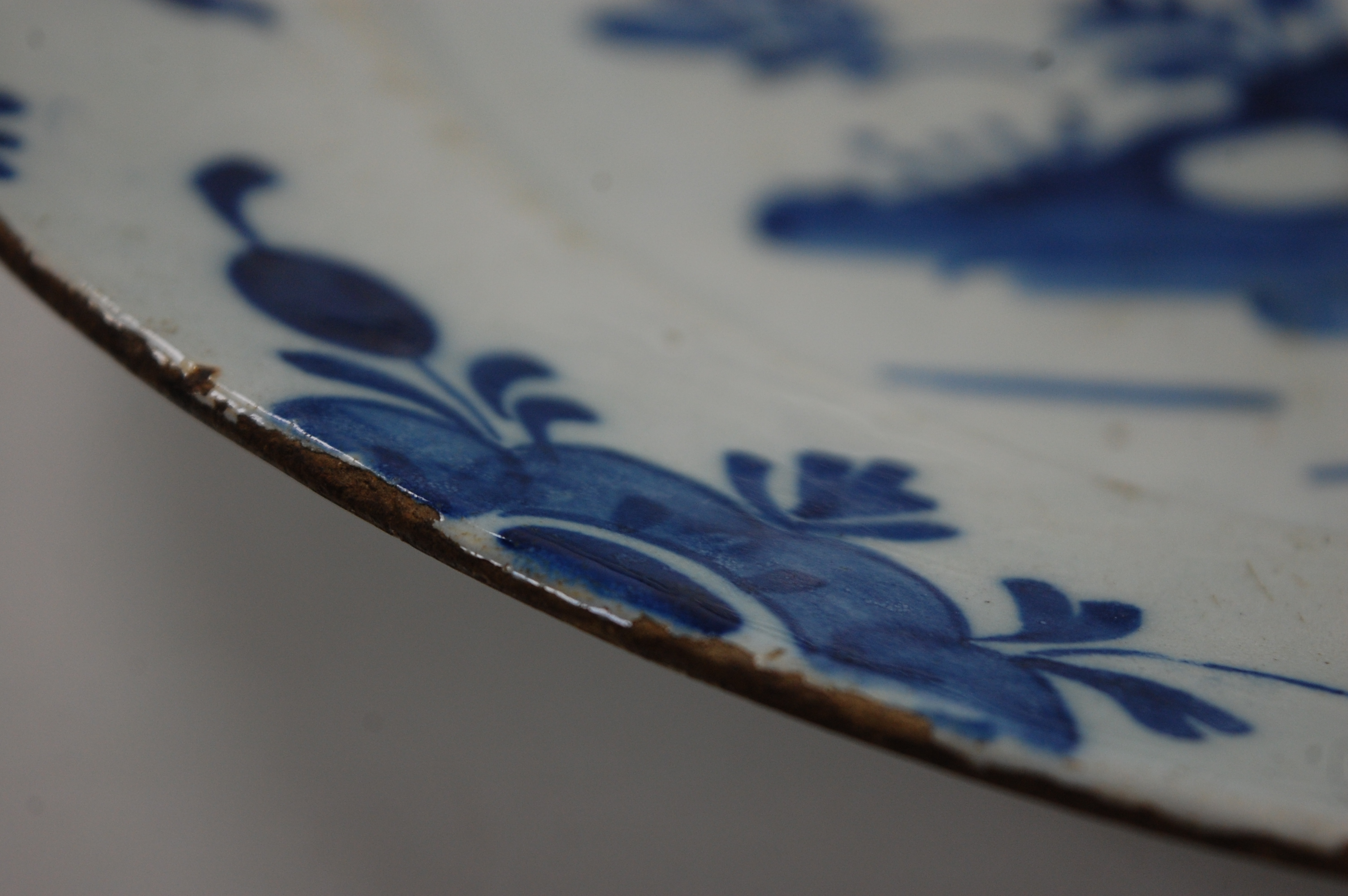 An 18th century English Delft blue & white charger, the centre typically decorated with flowers - Image 12 of 18