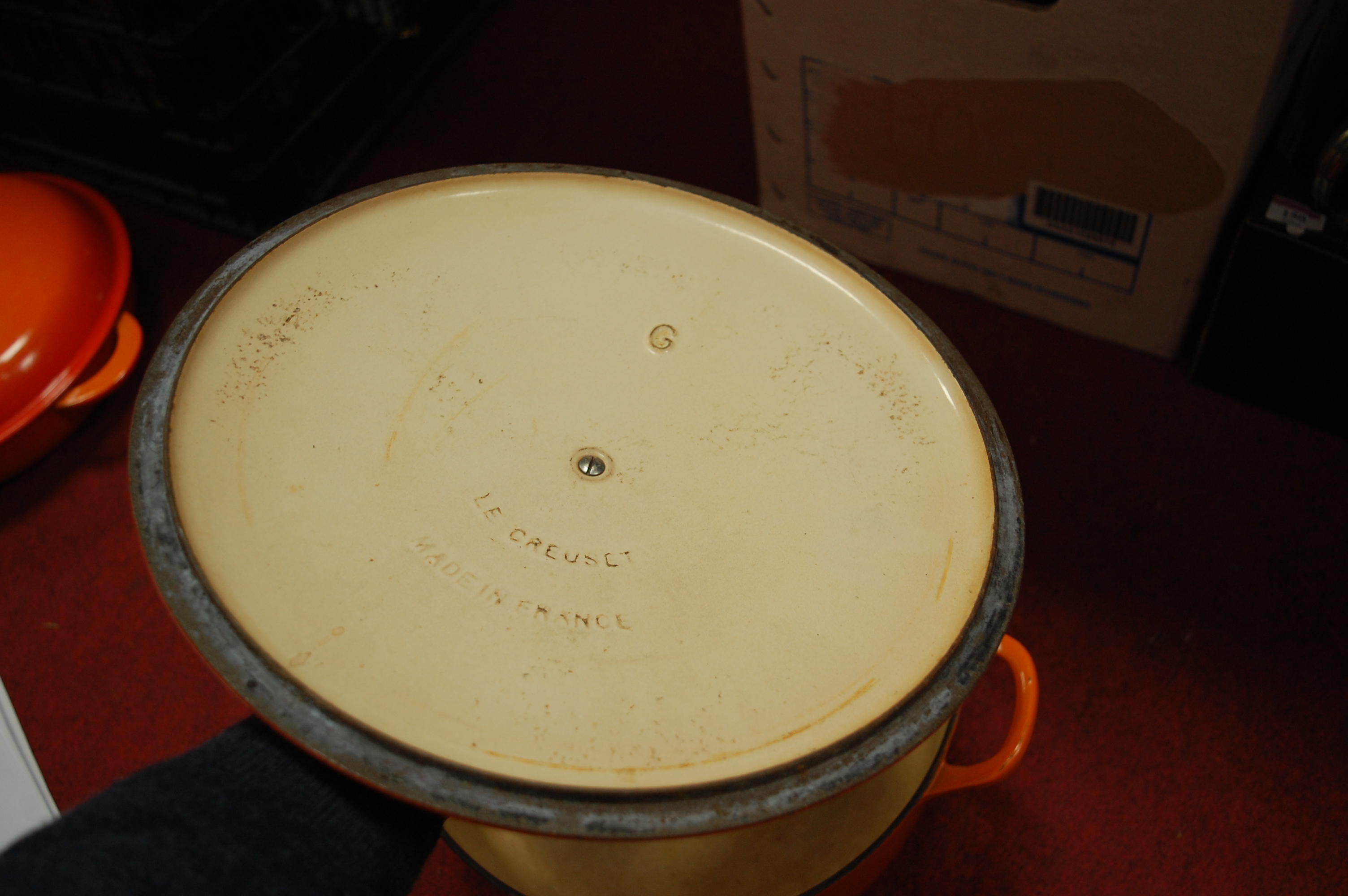 A Le Creuset orange enamelled casserole dish and cover together with one other smaller example (2) - Image 8 of 12