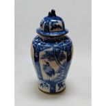 A large reproduction Chinese blue & white jar and cover of baluster form, each panel decorated