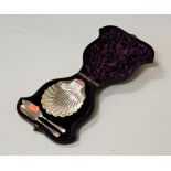A George V silver butter dish, of shell shape, with a matching butter knife, in fitted purple velvet