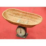 A set of early 20th century iron baby scales, with wicker basket, the circlar silvered dial