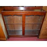 A 1930s mahogany ledgeback double door glazed china display cabinet, width 124cm