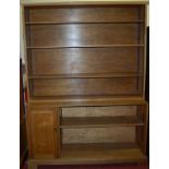 A mid-20th century light oak large free standing open two-tier bookshelf, having single recessed