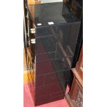 A pair of contemporary black mirrored glass square pedestals, together with a further smoky glass
