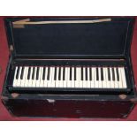 An early 20th century cased travelling piano