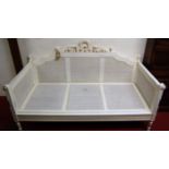 A French carved, white painted and double split cane inset day bed, in the Louis XVI taste, width