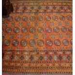 A Persian woollen rust ground Bokhara rug, 198 x 130cm