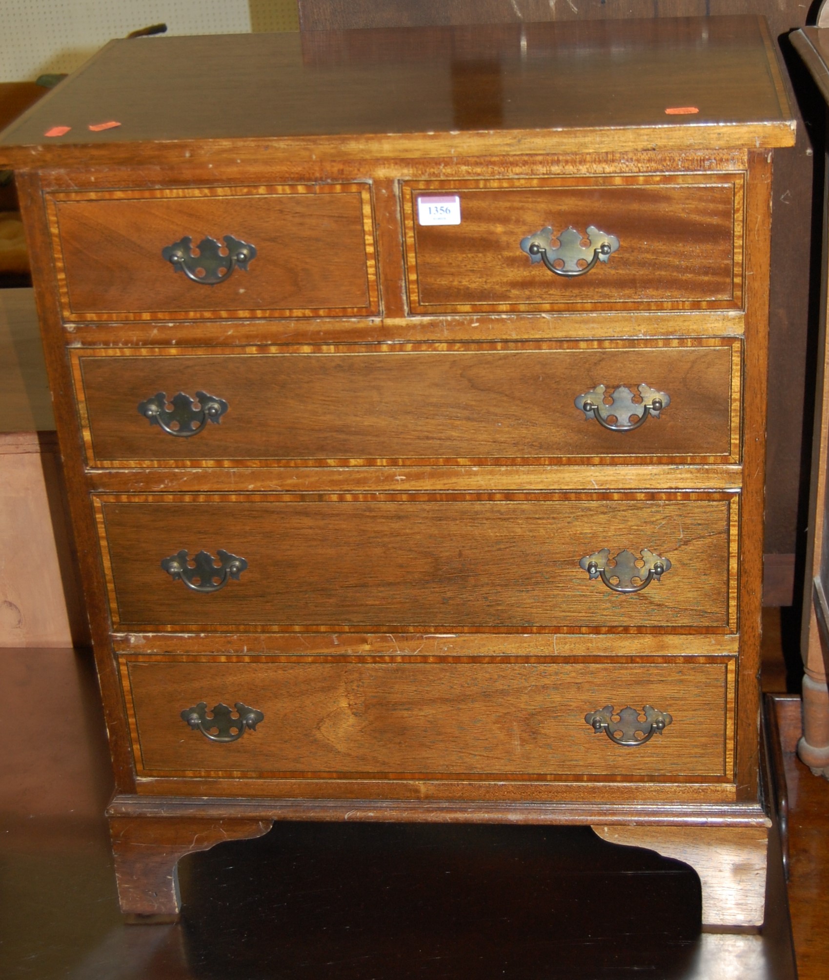 A mahogany and satinwood crossbanded chest of two short over three long drawers, width 62cm