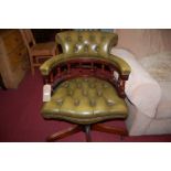 A contemporary mahogany green buttoned leather and further studded tub swivel desk chair, width