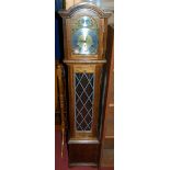 A contemporary Fen Clocks oak cased granddaughter clock, having an arched brass and silvered dial