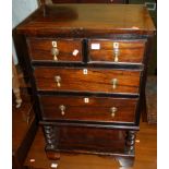 An unusual small rosewood and mahogany crossbanded chest of two short over two long drawers,