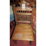 A set of four 19th century provincial Chippendale style oak dining chairs, together with a further