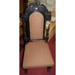 A circa 1900 carved and ebonised oak pad back and seat single dining chair, together with an early
