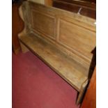 A rustic stained pine two panelled four seat church pew, width 168cm