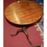 A George III mahogany circular tilt-top pedestal tripod table, raised on turned and reeded spiral