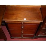 A low hardwood chest of three long drawers, having upper pull-out slide, width 59cm
