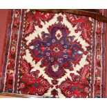 A Persian woollen cream and red ground hall runner, 310 x 80cm