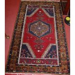 A Turkish woollen blue ground rug, with geometric stylised ground, 195 x 112cm