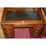 A late Victorian walnut and black leather inset twin pedestal writing desk, having a typical