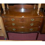 An early 20th century mahogany serpentine front three-quarter gallery back chest of two short over