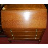 A 1930s oak slopefront three drawer writing bureau, width 92cm