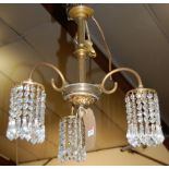 A French style gilt brass hanging three light ceiling pendant, the reeded branch arms terminating