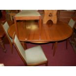 A 1970s G-Plan teak dining suite, comprising; D-end extending dining table with pull-out action