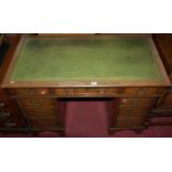 A circa 1900 oak and gilt tooled green leather inset twin pedestal writing desk, having typical