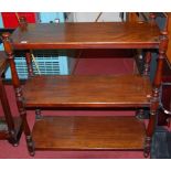 A mid-Victorian mahogany round cornered three-tier buffet whatnot, having turned columns, width