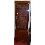 A mahogany narrow gun cupboard, having single astragal glazed upper door over lower panelled