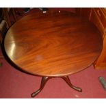 A mahogany circular tilt-top pedestal tripod table, having birdcage action, to plain turned column