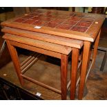 A 1970s Danish teak and tile top inset nest of three occasional tables, the largest width 57cm