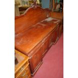 A mid-Victorian mahogany ledgeback sideboard, having three cushion frieze drawers over four