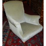 A late Victorian mahogany framed and upholstered Howard-type scroll armchair, raised on ring