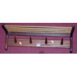 A 1970s teak wall mounted four peg coat rack, width 61cm